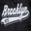 Brooklyn nets script tail full snap satin varsity jacket black 1